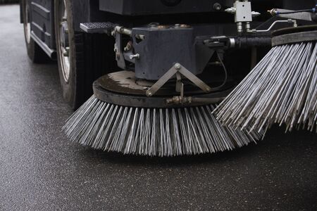 Closeup sweeper machine cleaning. Concept clean streets from debris. Selective focus.の写真素材