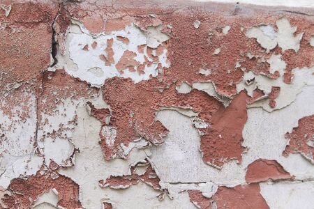 Old flaky cracked paint on grey wall, old paint background, selective focusの写真素材