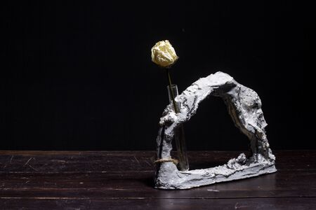 Dry beige rose in original coral vase, minimalism in interior, selective focusの写真素材