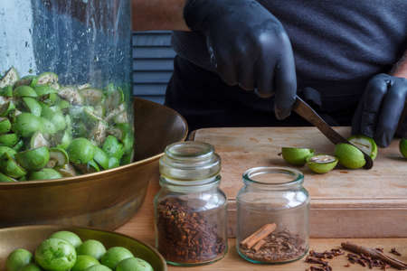 Step-by-step recipe for preparing of homemade Italian liquor nocino from green walnuts, real home kitchen and cooking, selective focusの写真素材