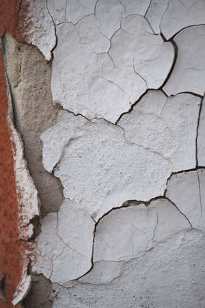 Old flaky cracked paint on gray wall, old paint background, selective focusの写真素材