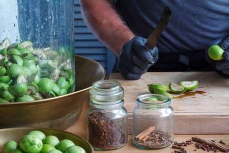 Step-by-step recipe for preparing of homemade Italian liquor nocino from green walnuts, real home kitchen and cooking, selective focusの写真素材