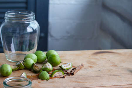 Step-by-step recipe for preparing of homemade Italian liquor nocino from green walnuts, real home kitchen and cooking, selective focusの写真素材