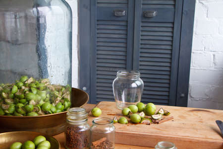 Step-by-step recipe for preparing of homemade Italian liquor nocino from green walnuts, real home kitchen and cooking, selective focusの写真素材