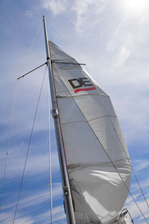 Kharkiv, Ukraine - July 28, 2020: Bottom view of mast and sail of yacht on blue sky backdrop, selective focusのeditorial素材