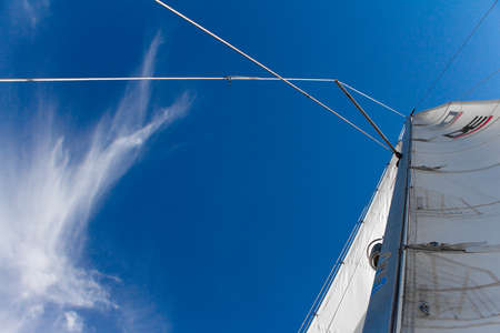 Kharkiv, Ukraine - July 28, 2020: Bottom view of mast and sail of yacht on blue sky backdrop, selective focusのeditorial素材