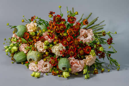 Close-up detail beautiful summer bouquet in bright colors, grey backdrop, selective focusの写真素材
