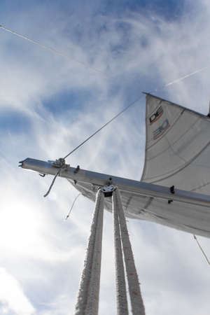 Kharkiv, Ukraine - July 28, 2020: Bottom view of mast and sail of yacht on blue sky backdrop, selective focusのeditorial素材