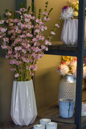 Florist shop modern interior, shelves with vases of dried flowers, bouquets of dried flowers, selective focusの写真素材