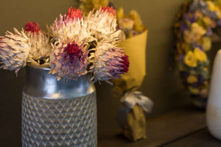Florist shop modern interior, shelves with vases of dried flowers, bouquets of dried flowers, selective focusの写真素材