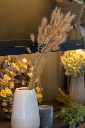 Florist shop modern interior, shelves with vases of dried flowers, bouquets of dried flowers, selective focusの写真素材