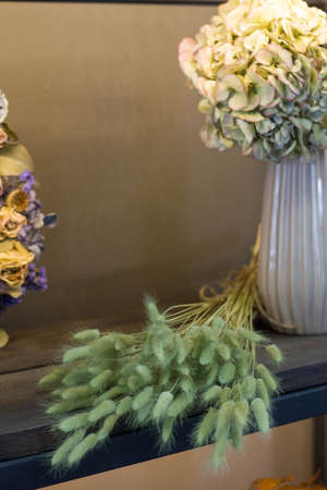 Florist shop modern interior, shelves with vases of dried flowers, bouquets of dried flowers, selective focusの写真素材
