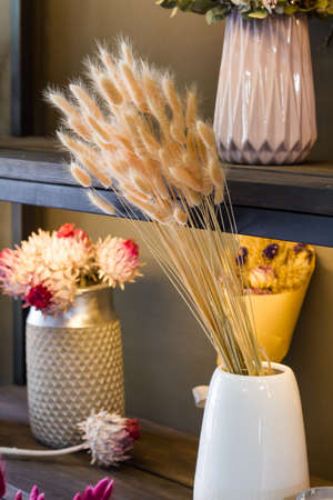 Florist shop modern interior, shelves with vases of dried flowers, bouquets of dried flowers, selective focusの写真素材