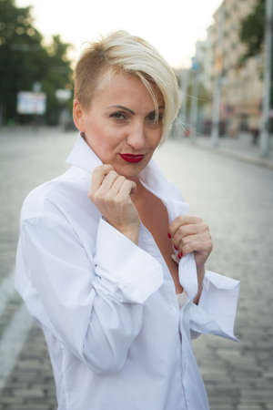 Happy beautiful woman in white shirt with various emotions close up portraitの写真素材
