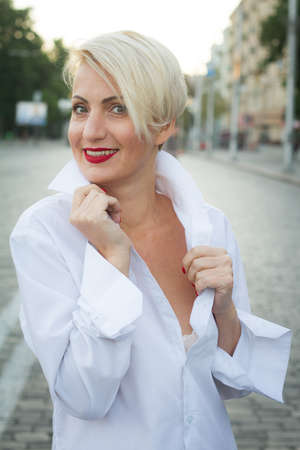 Happy beautiful woman in white shirt with various emotions close up portraitの写真素材
