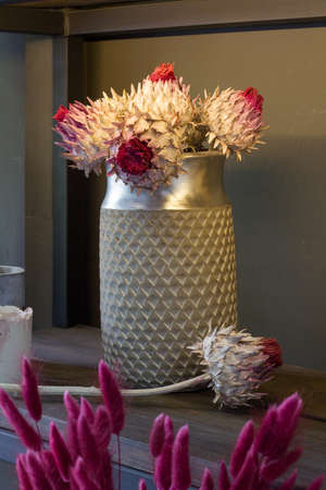 Florist shop modern interior, shelves with vases of dried flowers, bouquets of dried flowers, selective focusの写真素材