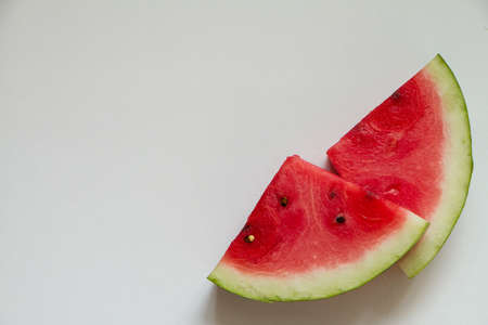 Two slices of ripe red watermelon on white background, top viewの写真素材