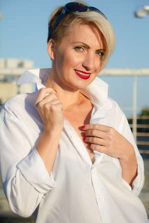 Happy beautiful woman in white shirt with various emotions close up portraitの写真素材