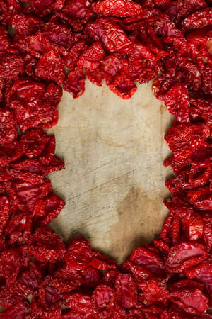 Close up sundried tomatoes with spices and olive oil on wooden cutting board, background or concept, selective focusの写真素材