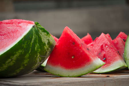 Fresh red ripe watermelon on wooden cutting board, picnic concept, selective focus
