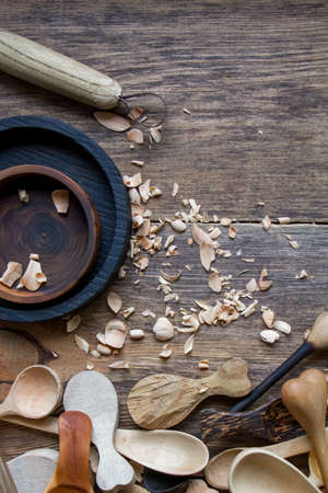 Handmade wooden kitchen utensils and stock-knife, top view lot of billets, spoons and plates on wooden table, selective focusの写真素材