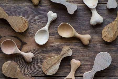 Handmade wooden kitchen utensils, top view lot of billets and spoons on wooden table, selective focusの写真素材