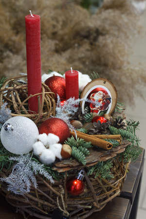Christmas or New Year composition. Wicker basket with fir branches decorated by natural materials on grey backgroundの写真素材