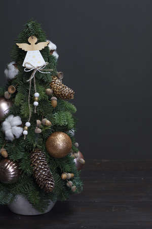 Christmas tree made of fresh Nobilis spruce, decorated with festive ornaments and pine conesの写真素材