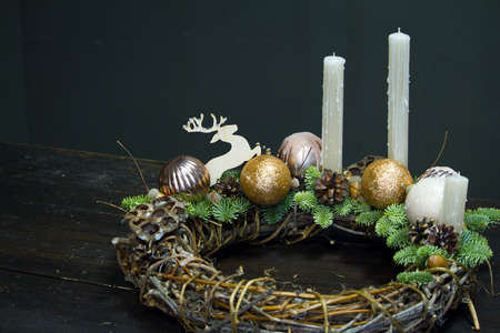 Advent wreath made of natural materials, minimalistic decor of grapevine, fir branches, candle decor on wooden backgroundの写真素材