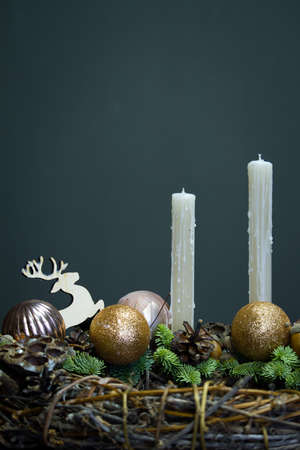 Advent wreath made of natural materials, minimalistic decor of grapevine, fir branches, candle decor on wooden backgroundの写真素材