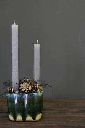 Minimalistic christmas composition with pine branches, cones and candles, new year concept, greeting cardの写真素材