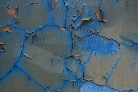 Rough textured blue wall with stains, selective focus