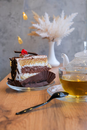 Chocolate cake with tea set in cafe, elegant serving of dessert in cafe, selective focusの写真素材