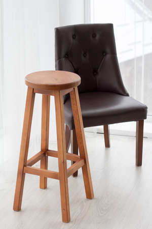 Modern minimalistic scandinavian style interior, black chair and wooden table, panoramic windows,...