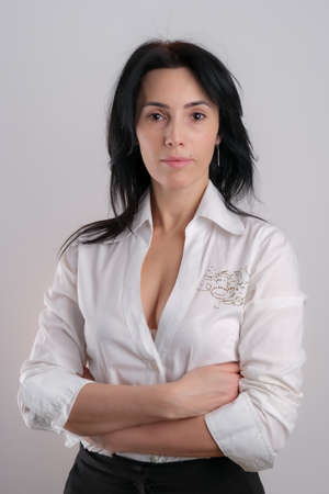 Portrait of beautiful mature brunette woman isolated on grey white background, copy spaceの写真素材