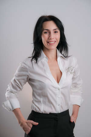 Portrait of beautiful mature brunette woman isolated on grey white background, copy spaceの写真素材