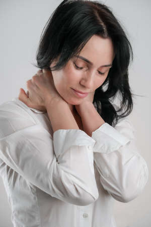 Portrait of beautiful mature brunette woman isolated on grey white background, copy spaceの写真素材