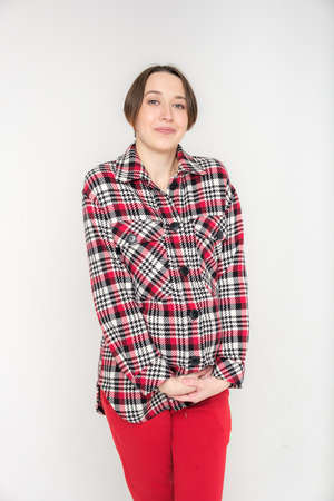 Studio portrait of young adult woman in warm home clothes, happy pregnancy concept, white backdrop
