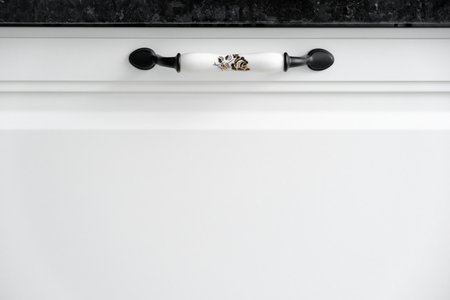 Extremely close up detail of vintage white cabinet, original ceramic handles, selective focus, copy spaceの写真素材