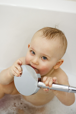 happy funny baby laughing and bathed in the bathの写真素材