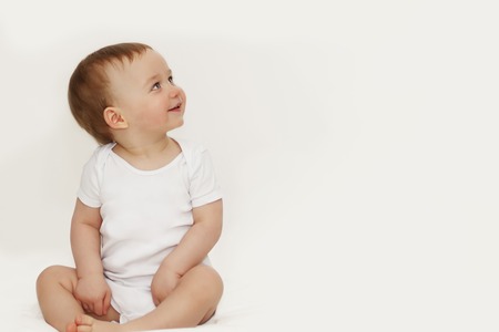 Little boy with blue eyes looking upの写真素材