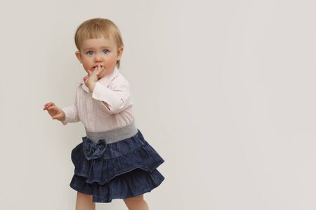 Portrait of a little girl with blue eyes on a white backgroundの写真素材