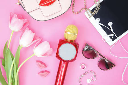 Woman accessories with flowers and microphone on pinkの写真素材
