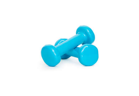 Blue dumbbells on a white background. Isolated sports tool. Female fitness, gym. Sports for women and girls. Beautiful sports object for banner designの写真素材