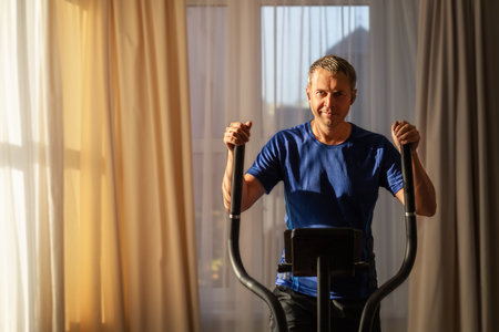 Middle aged man doing sports at dawn at home.の写真素材