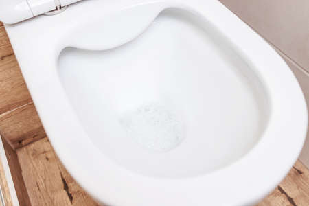 clean, white, new toilet close-up in the bathroomの写真素材