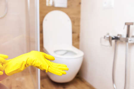 mockup for a bottle of product, hands in glove on the background of the bathroomの写真素材