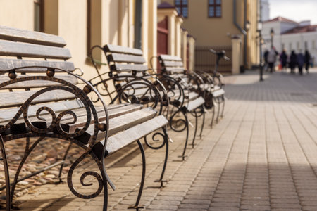 row of benches on an old street in the city, sunny summer day, copy spaceの写真素材