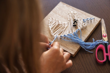 Close-up of a child hands creating string art. Enhancing concentration, creativity, and sensory...