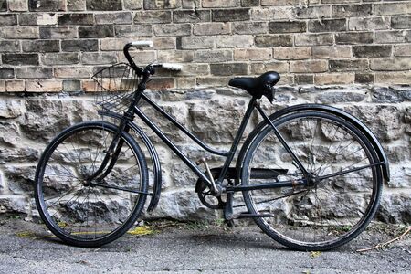 Old bicycle set and left idle in alley wayの写真素材